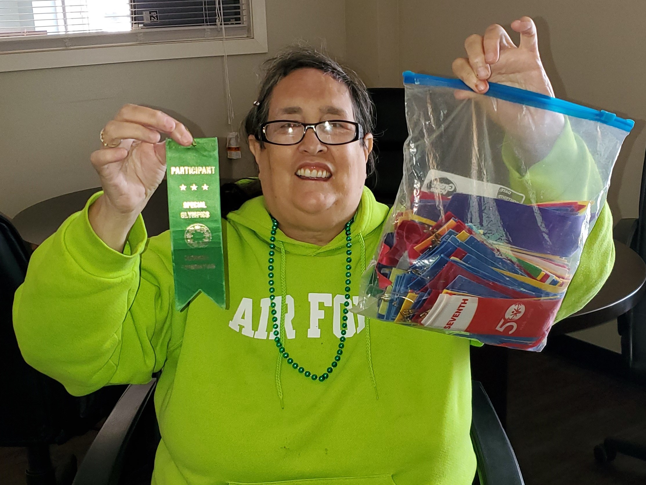 woman holding winning ribbons